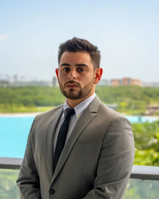 Enrique Ponte Ojeda on a balcony overlooking the water in Miami