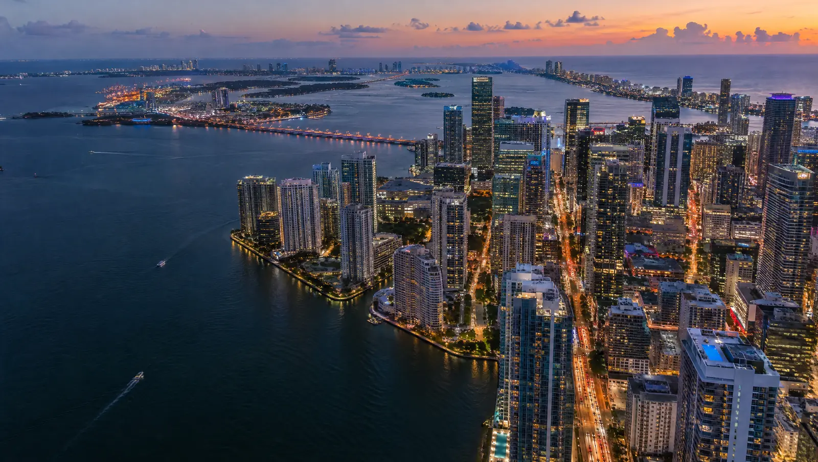 Illustration: aerial view of Brickell and Biscayne Bay at dusk